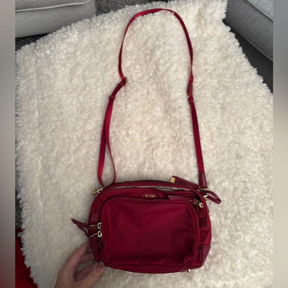 Tumi red nylon crossbody travel bag